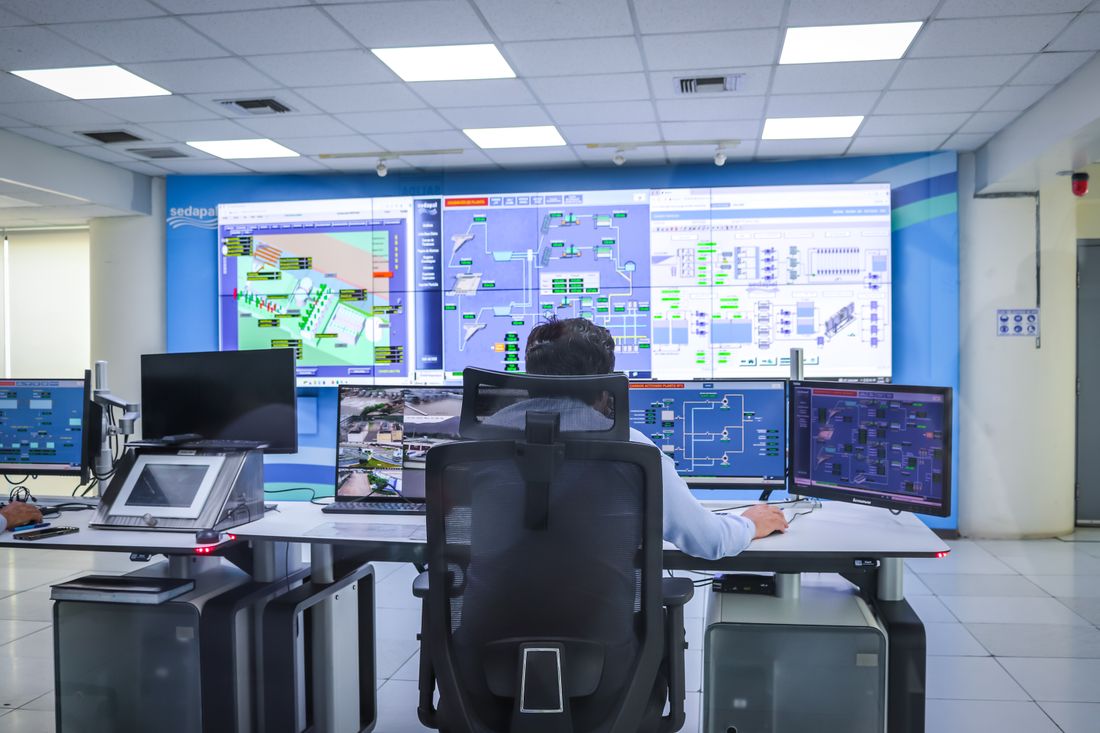 Engineer monitoring process data in a control room